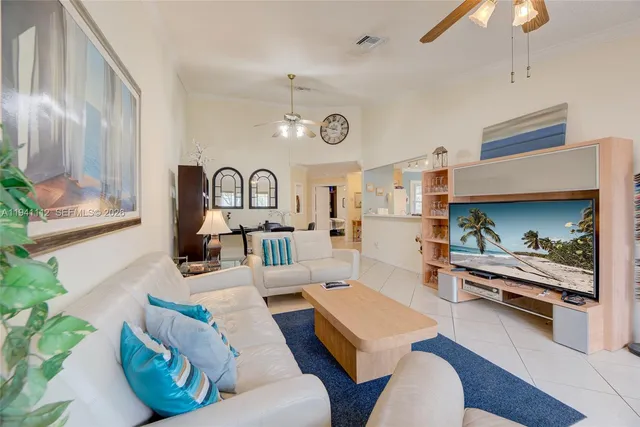 a living room with furniture fireplace and wooden floor