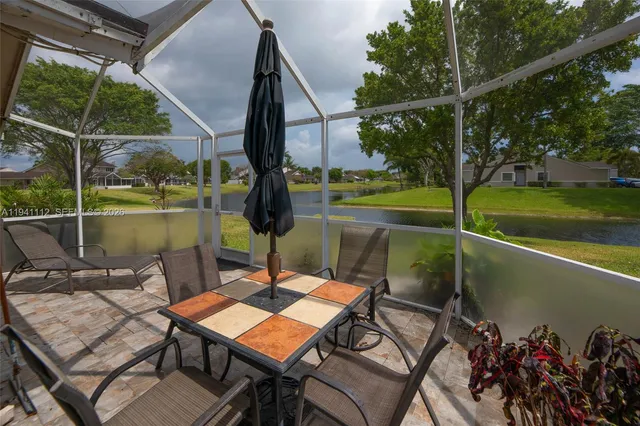 a view of a patio with a table chairs and a table