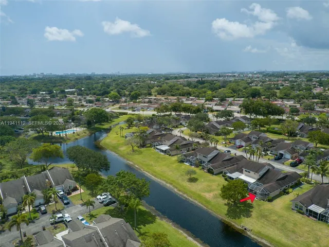 an aerial view of lake residential houses with outdoor space and swimming pool