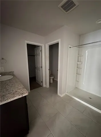 a kitchen with stainless steel appliances a sink a stove top oven and cabinets