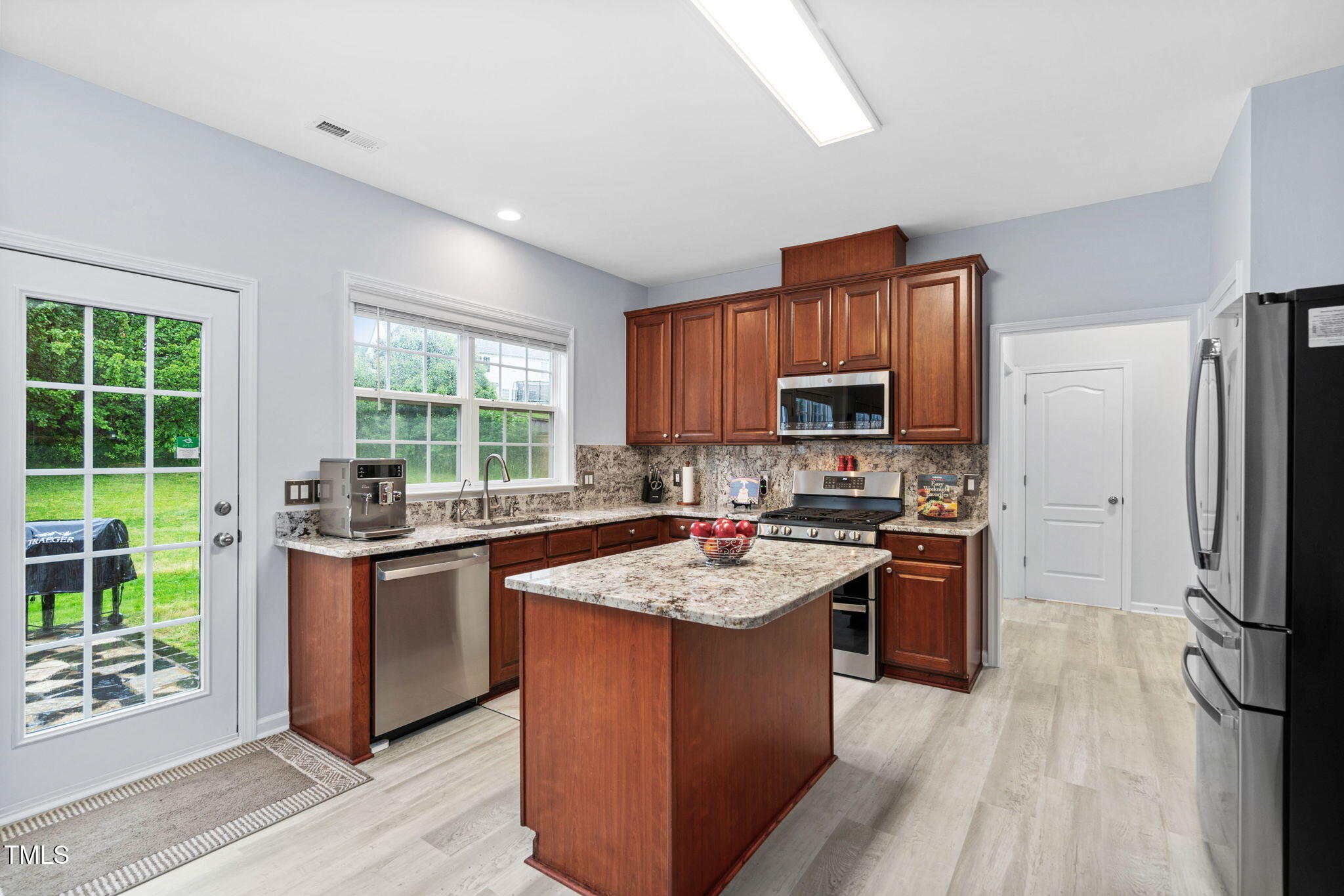 7612 Vista Del Rey Lane Raleigh, NC 27613 - Photo 23 of 73 Island Kitchen with Cherry Cabinets & Granite Countertops & Backsplash