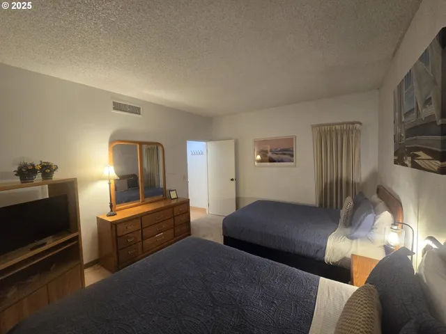 a bathroom with a double vanity sink toilet mirror and shower