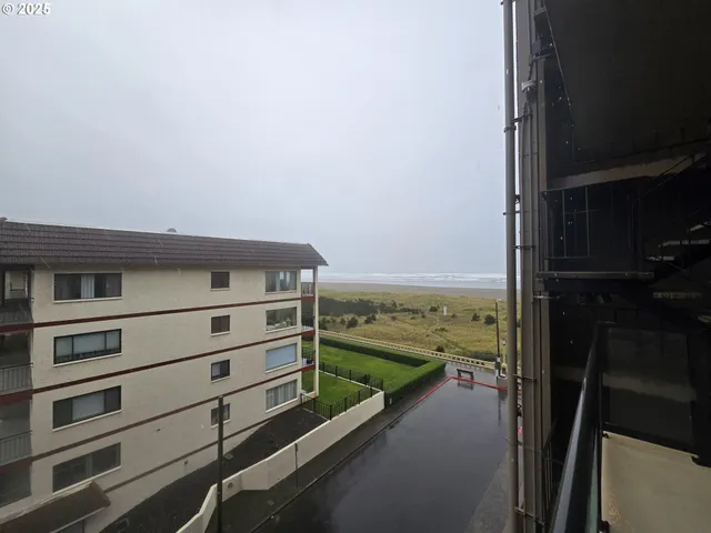 a view of a large building with a big yard and plants