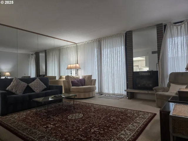 a living room with furniture and a rug