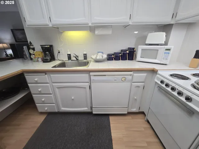 a kitchen with cabinets appliances and a sink