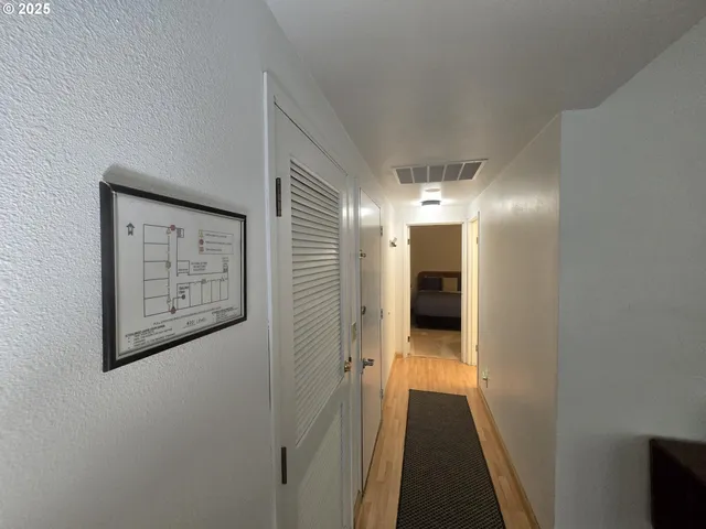 a bedroom with bed and a night stand