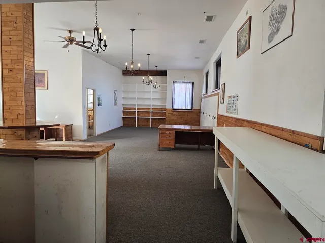 a kitchen with kitchen island a sink stove and wooden floor