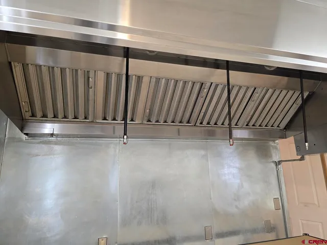 a kitchen with stainless steel appliances a refrigerator and a stove