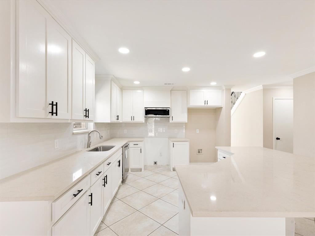 720 Pheasant Road Saginaw, TX 76131 - Photo 12 of 40 a large white kitchen with cabinets and a sink