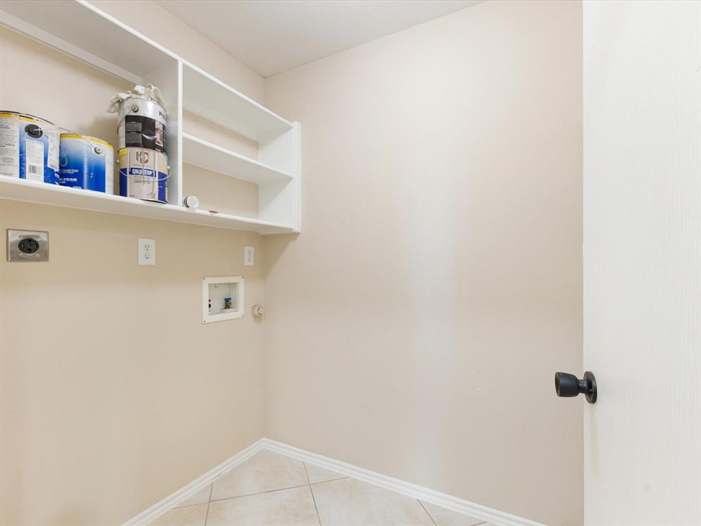 720 Pheasant Road Saginaw, TX 76131 - Photo 20 of 40 a view of a hallway with a refrigerator