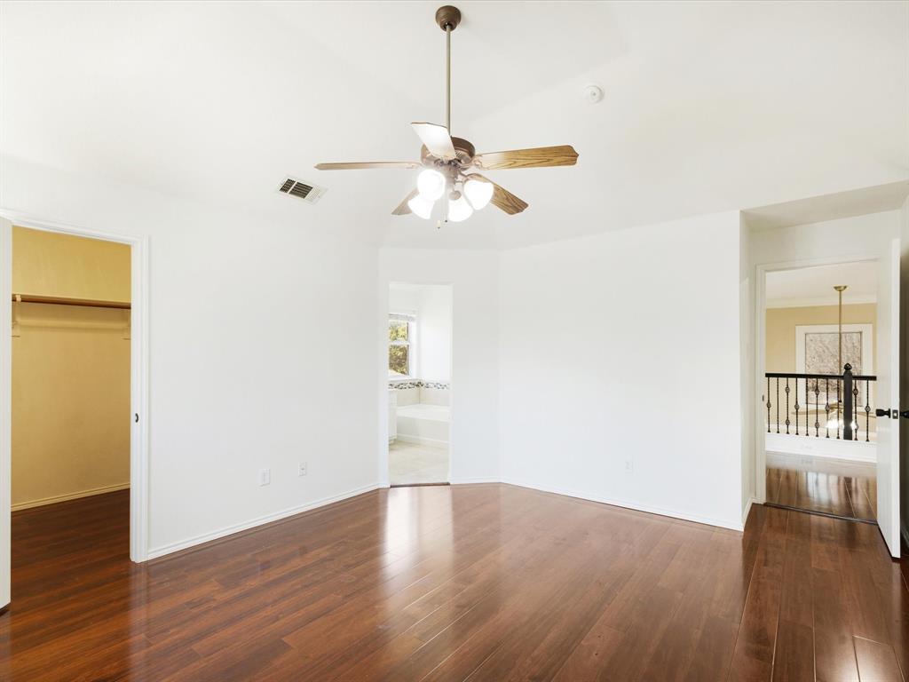 720 Pheasant Road Saginaw, TX 76131 - Photo 25 of 40 a view of a room with wooden floor and a ceiling fan