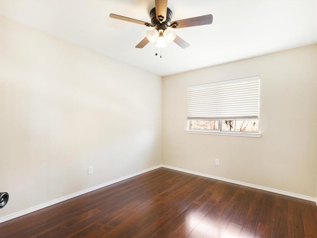 720 Pheasant Road Saginaw, TX 76131 - Photo 28 of 40 an empty room with wooden floor and fan