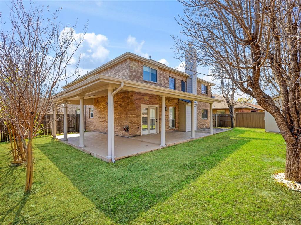 720 Pheasant Road Saginaw, TX 76131 - Photo 30 of 40 a view of a house with a yard