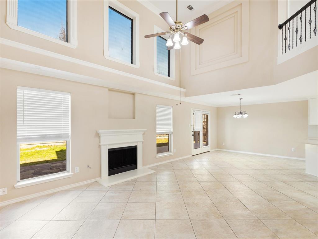 720 Pheasant Road Saginaw, TX 76131 - Photo 6 of 40 a view of an empty room with a fireplace and a window
