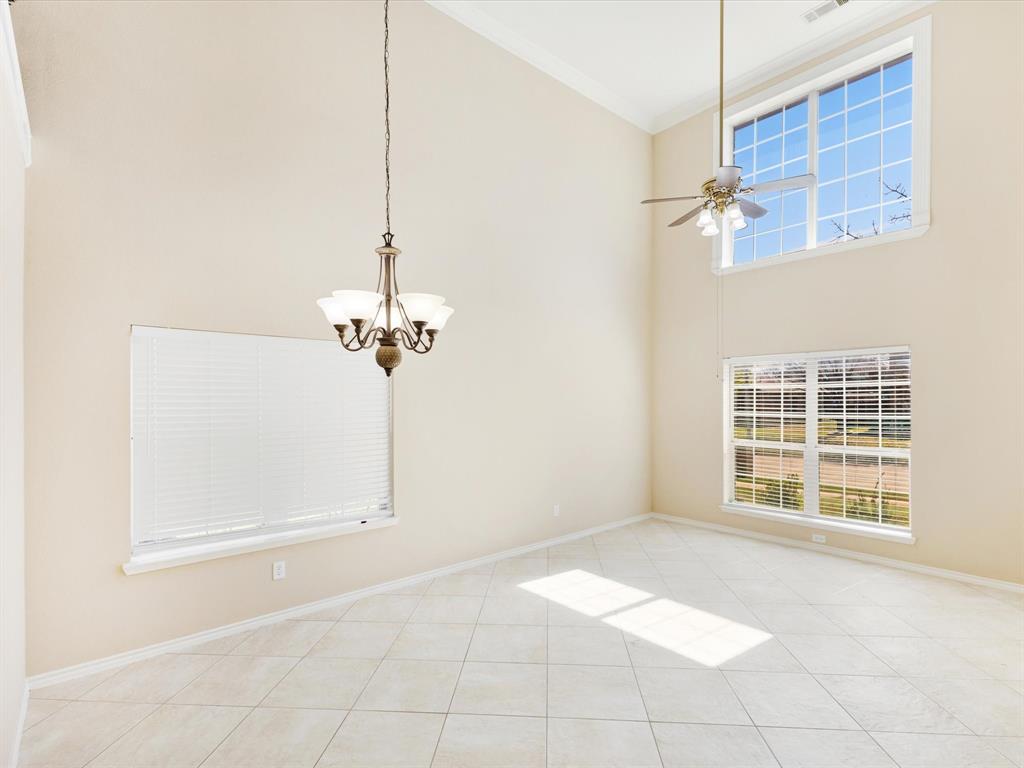 720 Pheasant Road Saginaw, TX 76131 - Photo 7 of 40 a view of a room with a ceiling fan and a window