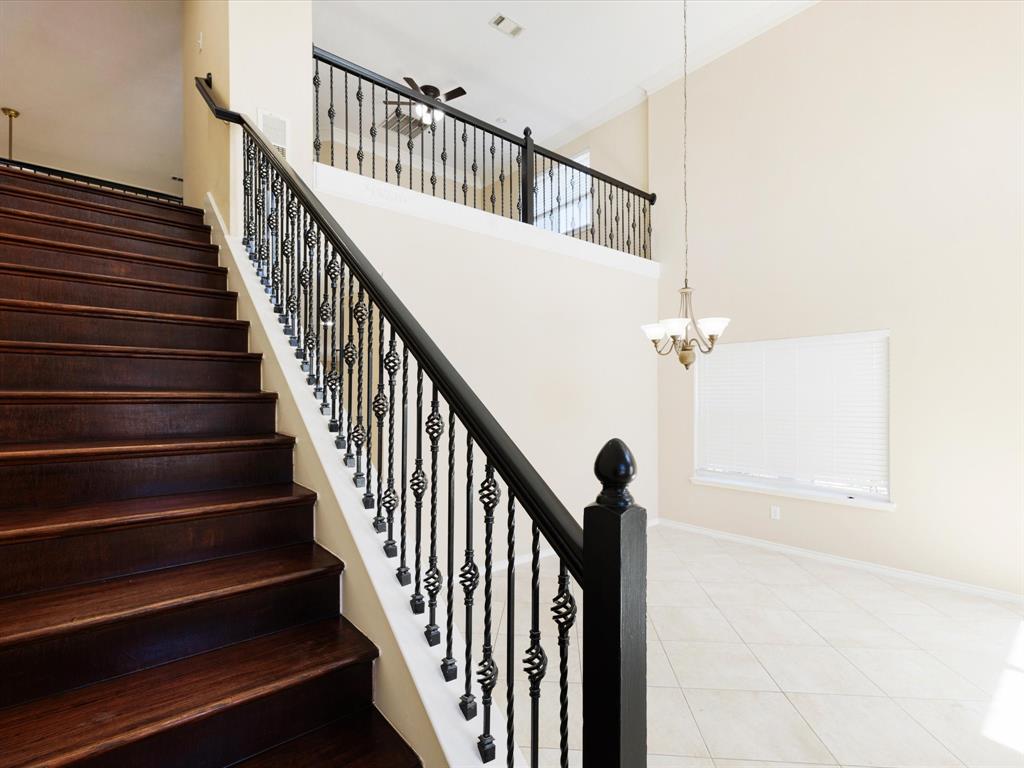 720 Pheasant Road Saginaw, TX 76131 - Photo 9 of 40 a view of staircase with railing and white walls