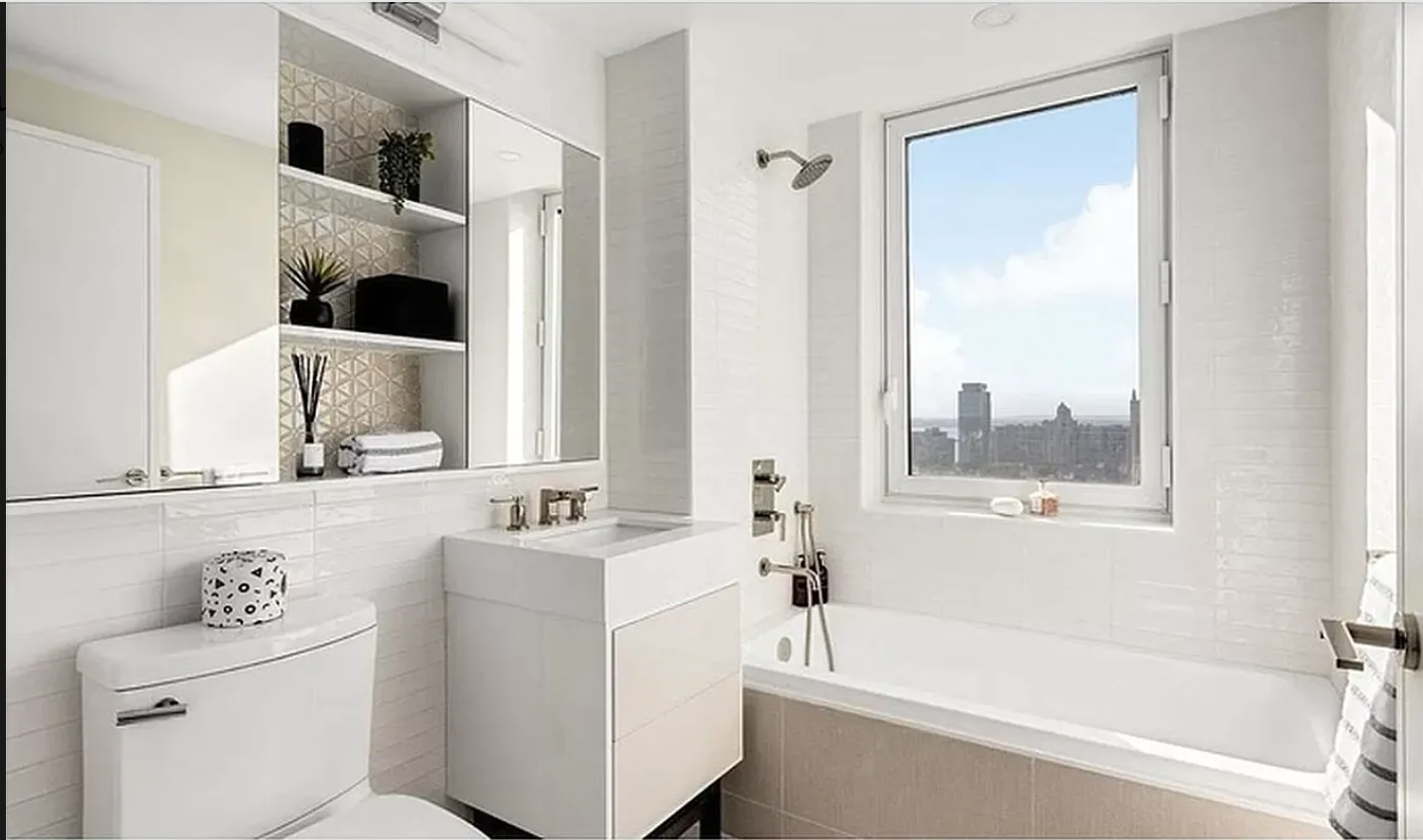 a bathroom with a bathtub sink and mirror