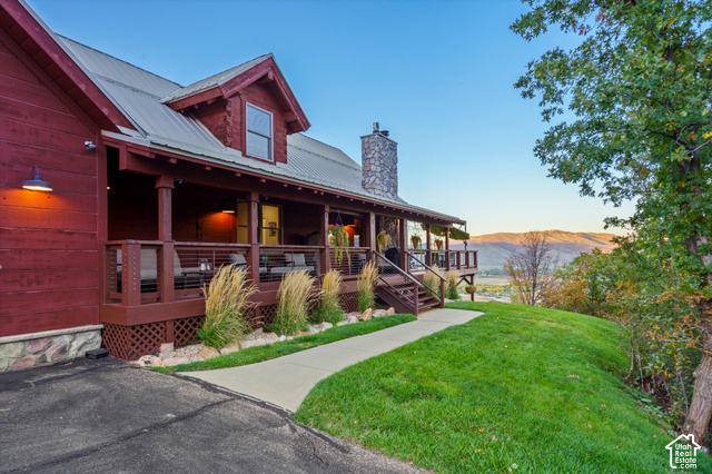 5878 Snowbasin Road Huntsville, UT 84317 - Photo 60 of 90 Expansive elevated deck with a stone-clad chimney and a metal roof