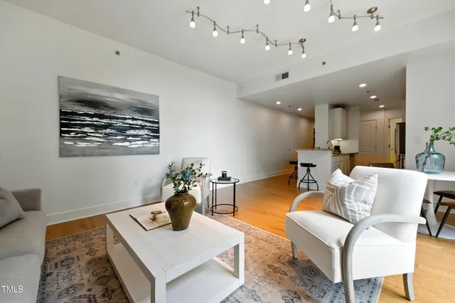 a living room with furniture and a chandelier