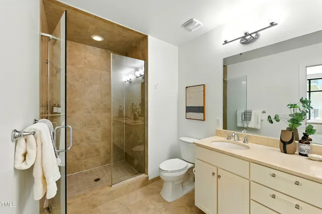 a bathroom with a shower sink and mirror