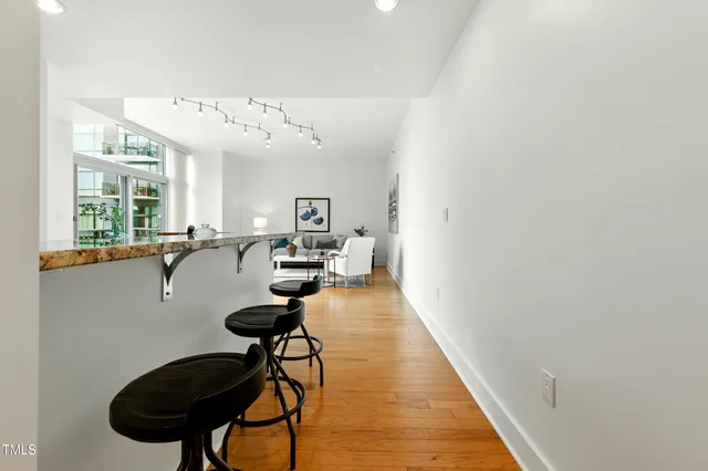a view of a livingroom with furniture and a floor to ceiling window