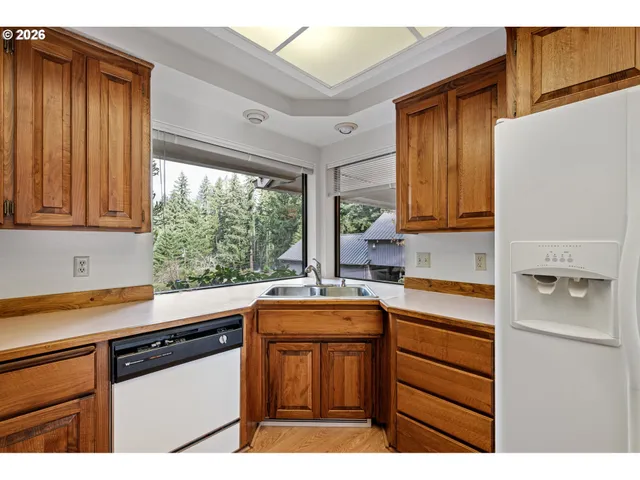 a kitchen with a sink a counter top space and stainless steel appliances