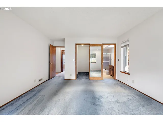 a view of an empty room with glass door