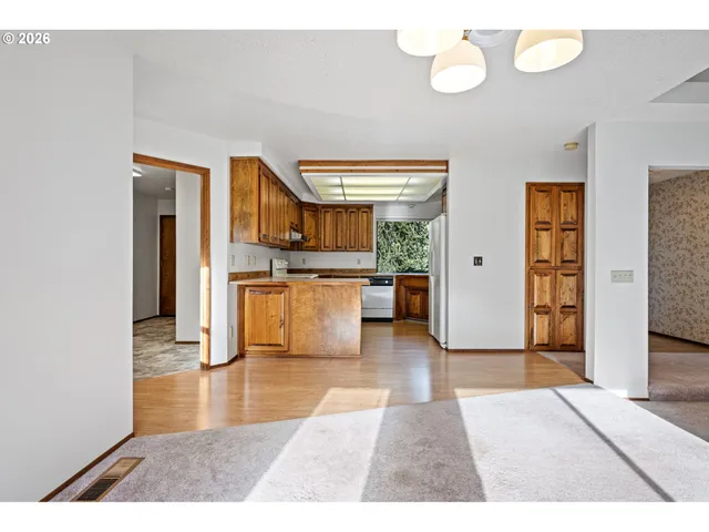 a view interior of kitchen and hall with wooden floor