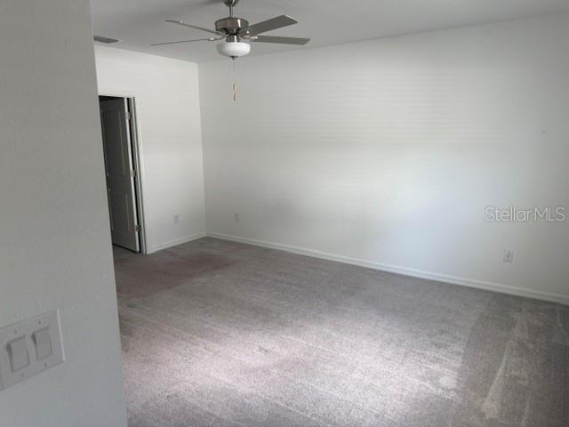 6259 Back Forty Loop Zephyrhills, FL 33541 - Photo 9 of 22 an empty room with a fan