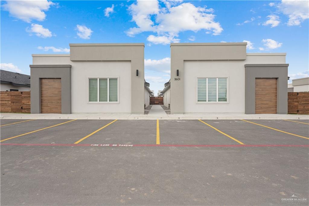 3601 Vanessa Lane, Unit 1 Weslaco, TX 78599 - Photo 1 of 16 View of building exterior with uncovered parking and fence