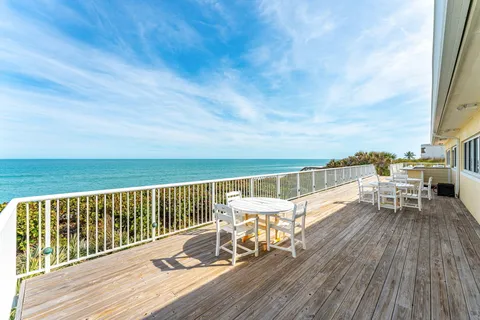 a view of balcony with furniture and wooden floor