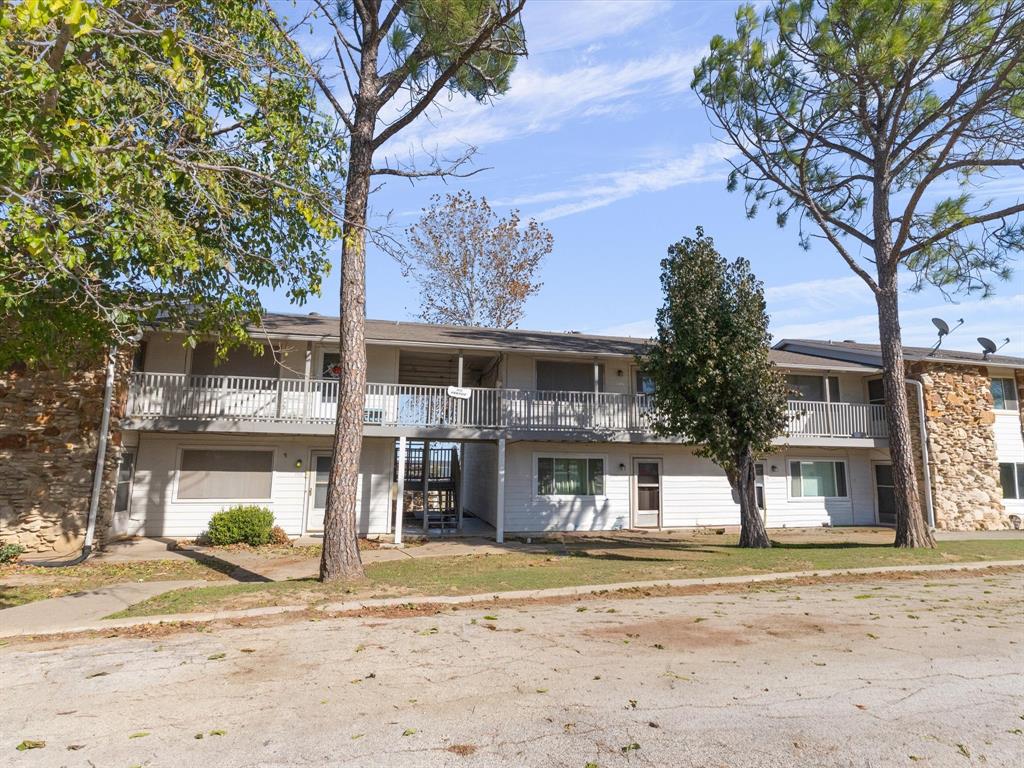 102 Harbor Drive, Unit 204 Runaway Bay, TX 76426 - Photo 1 of 17 a front view of a house with a yard and trees