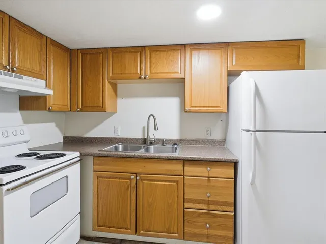 a kitchen with appliances cabinets and a counter top space