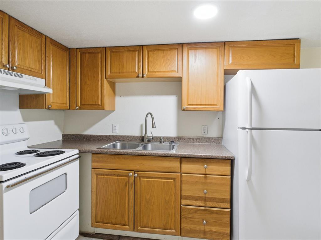 102 Harbor Drive, Unit 204 Runaway Bay, TX 76426 - Photo 8 of 17 a kitchen with appliances cabinets and a counter top space
