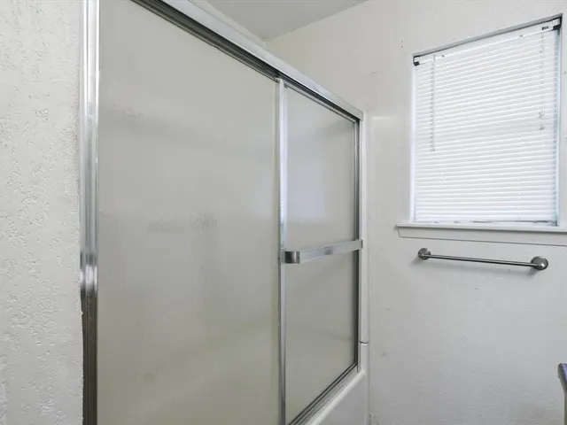 a bathroom with a glass shower door