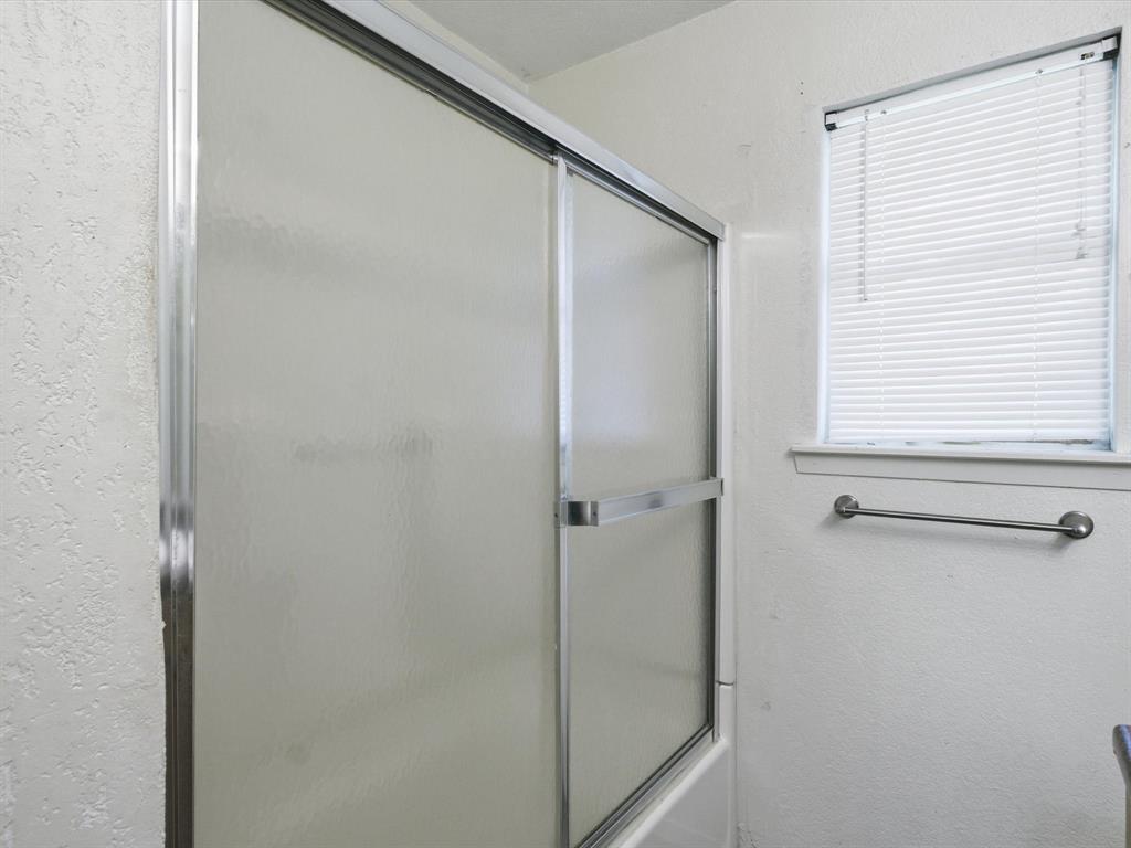 102 Harbor Drive, Unit 204 Runaway Bay, TX 76426 - Photo 10 of 17 a bathroom with a glass shower door