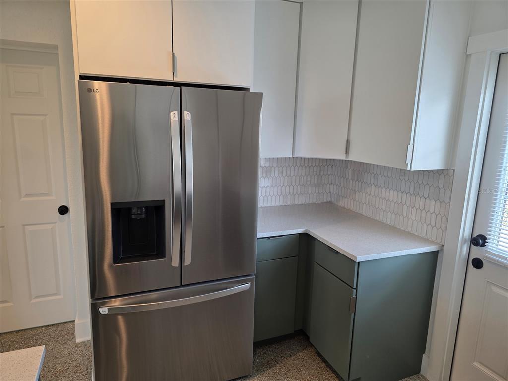 430 80th Way St. Pete Beach, FL 33706 - Photo 11 of 42 a kitchen with metallic refrigerator freezer and a dishwasher