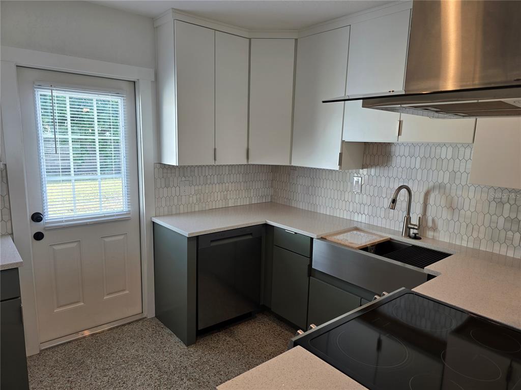 430 80th Way St. Pete Beach, FL 33706 - Photo 12 of 42 a kitchen with a sink cabinets and window