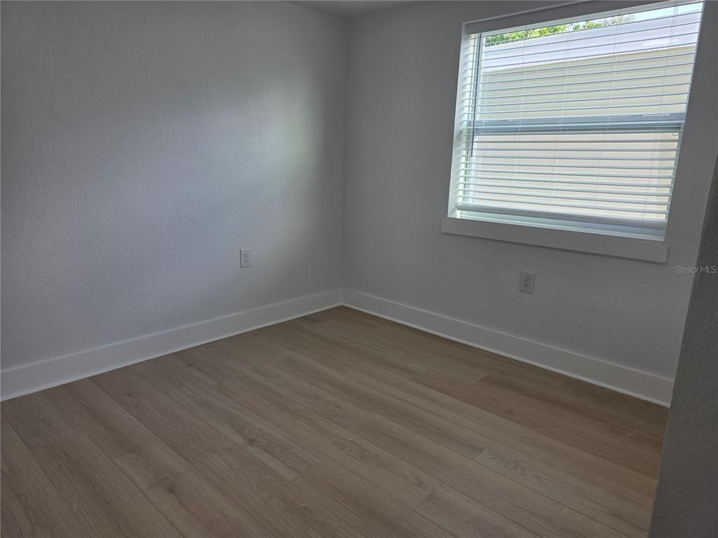 430 80th Way St. Pete Beach, FL 33706 - Photo 13 of 42 a view of a room that has wooden floor and a window