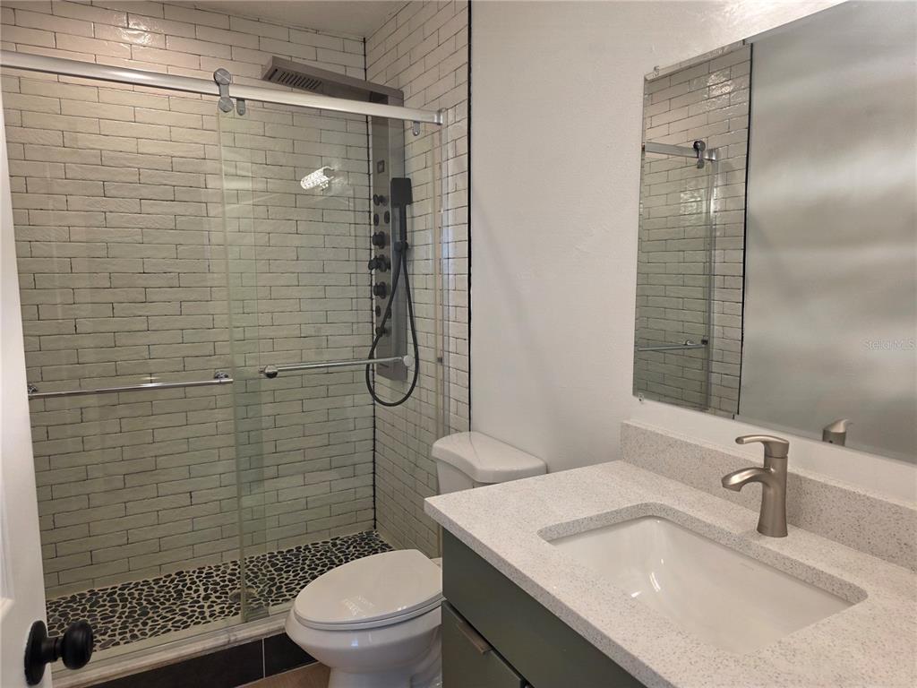 430 80th Way St. Pete Beach, FL 33706 - Photo 16 of 42 a bathroom with a sink toilet and shower