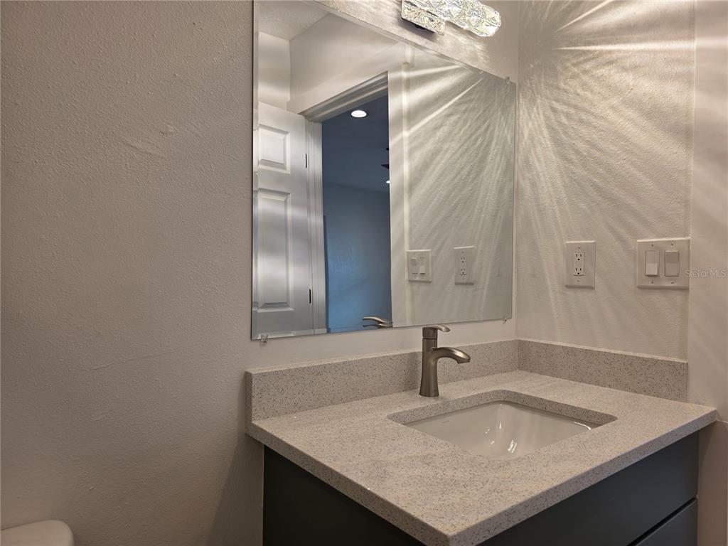 430 80th Way St. Pete Beach, FL 33706 - Photo 18 of 42 a bathroom with a sink and a mirror