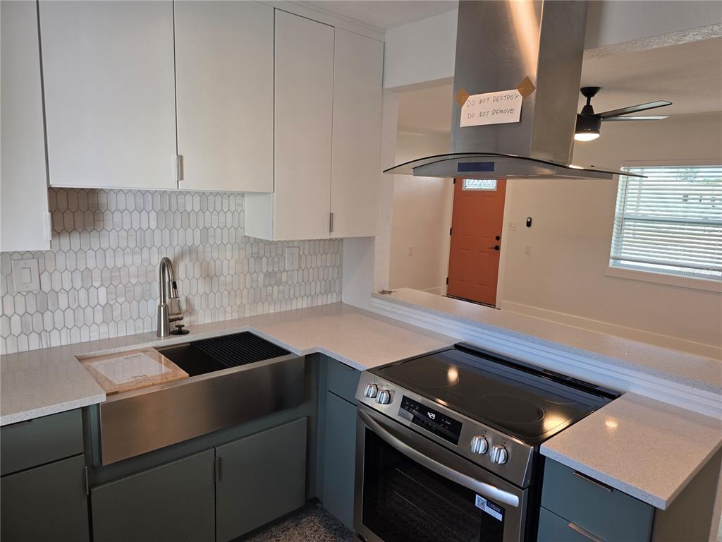 430 80th Way St. Pete Beach, FL 33706 - Photo 2 of 42 a kitchen with a stove and a white cabinets