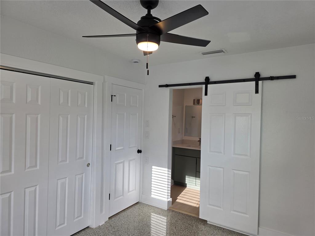 430 80th Way St. Pete Beach, FL 33706 - Photo 22 of 42 a bathroom with a shower and a ceiling fan