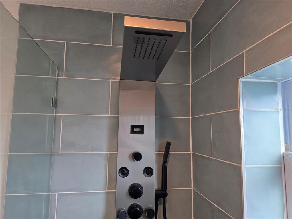 430 80th Way St. Pete Beach, FL 33706 - Photo 27 of 42 a bathroom with a shower and a sink