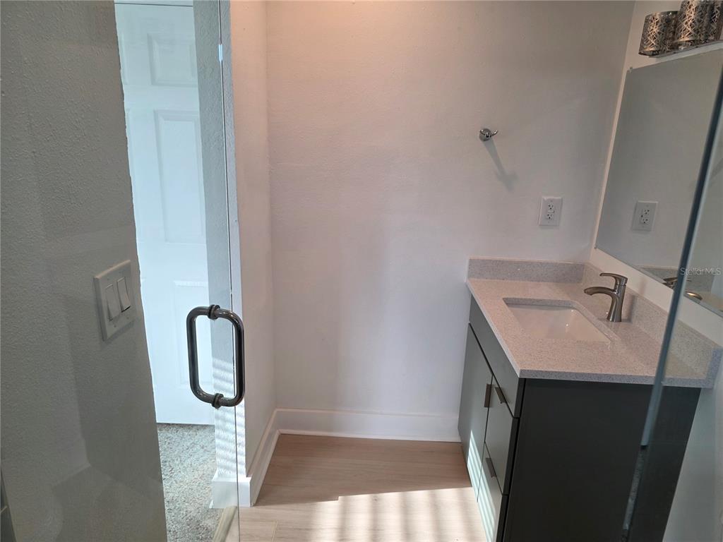 430 80th Way St. Pete Beach, FL 33706 - Photo 28 of 42 a bathroom with a sink and mirror