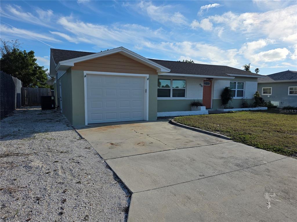 430 80th Way St. Pete Beach, FL 33706 - Photo 4 of 42 a front view of a house with a yard