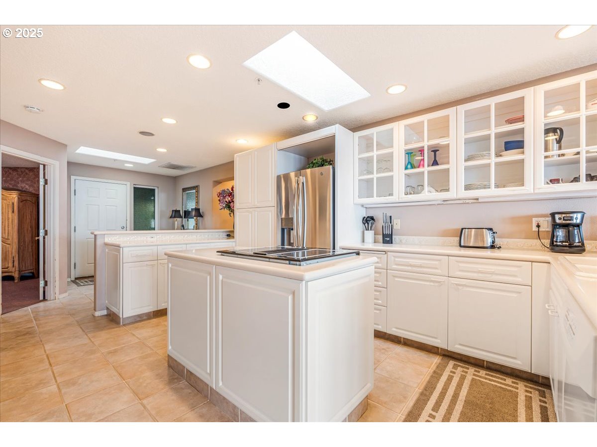 361 South Promenade, Unit 502 Seaside, OR 97138 - Photo 12 of 46 a kitchen with white cabinets and sink