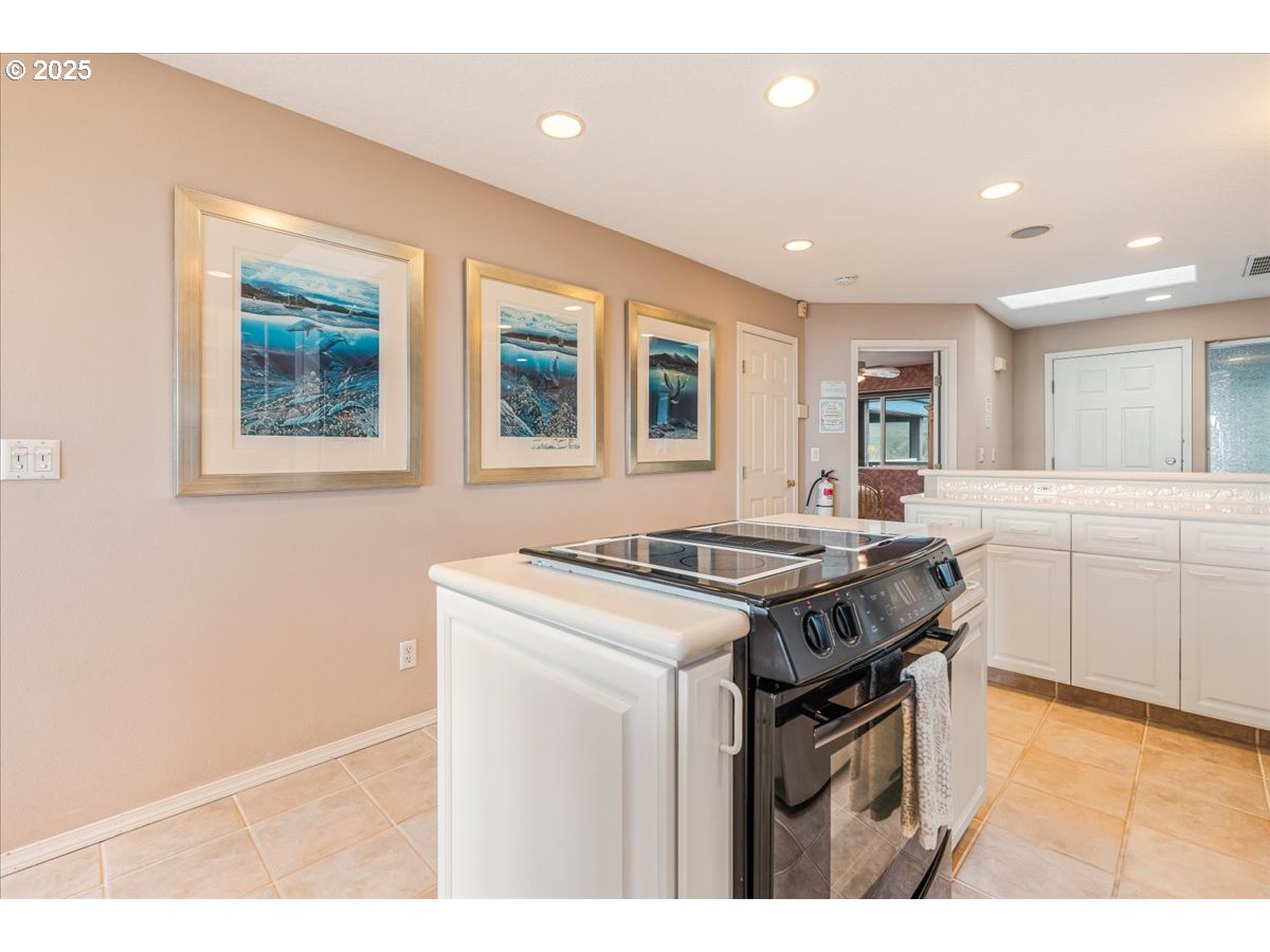 361 South Promenade, Unit 502 Seaside, OR 97138 - Photo 13 of 46 a kitchen with stainless steel appliances granite countertop a stove a sink dishwasher and a refrigerator