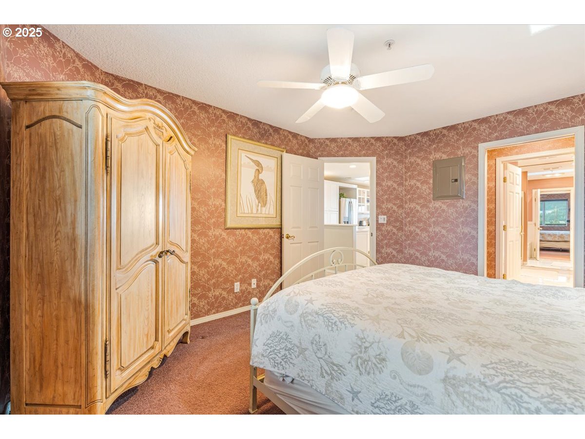 361 South Promenade, Unit 502 Seaside, OR 97138 - Photo 31 of 46 a bedroom with a bed and a mirror