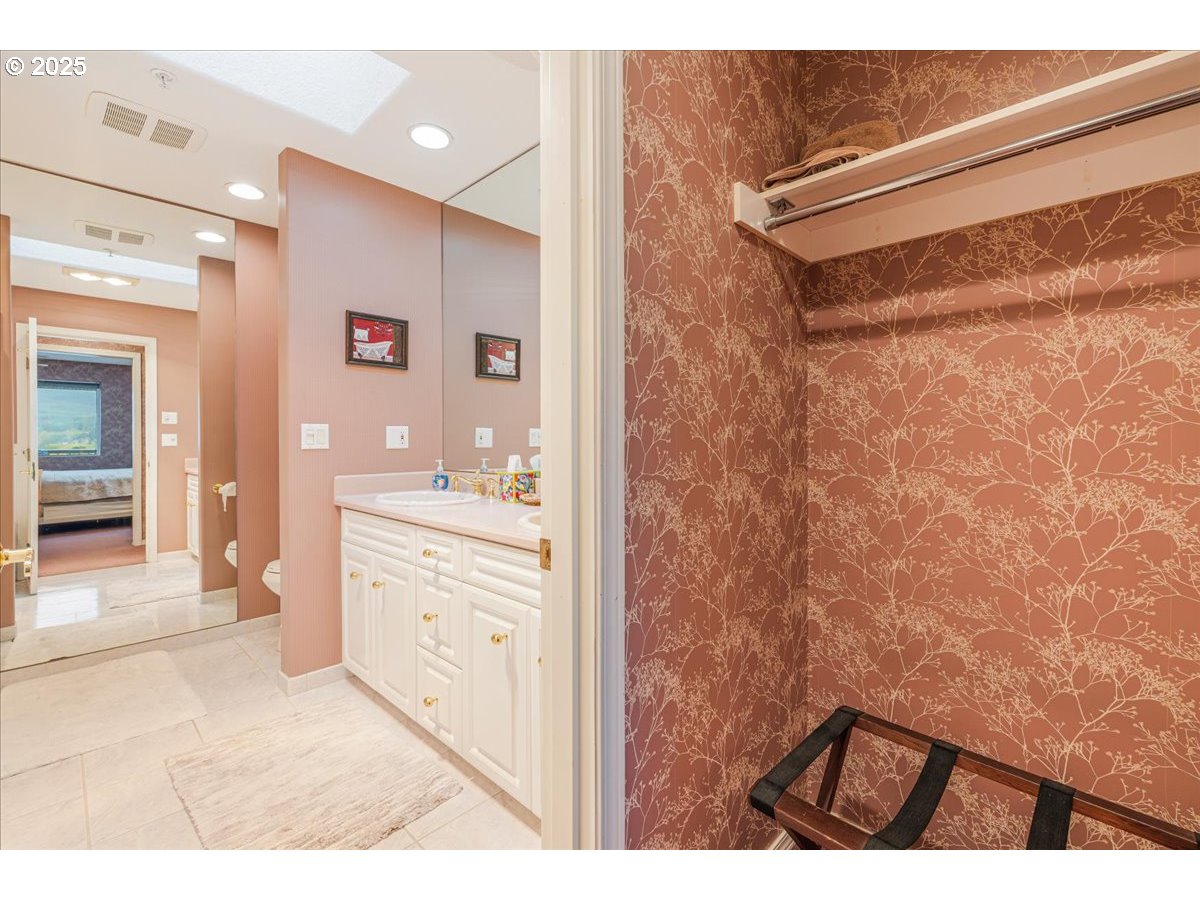 361 South Promenade, Unit 502 Seaside, OR 97138 - Photo 33 of 46 a bathroom with a sink and a mirror